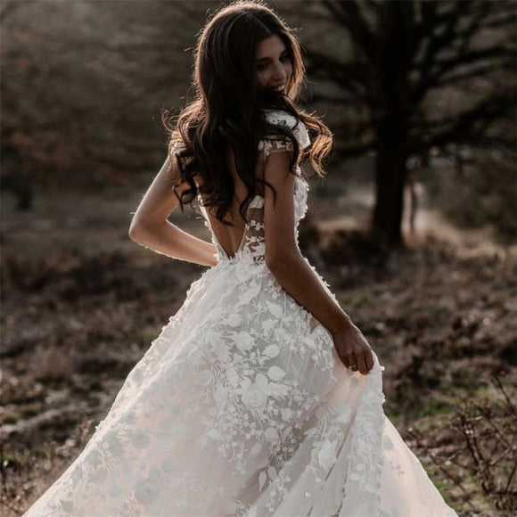 Elegant Bohemian Bridal Gown Featuring a Deep V-Neck, Short Sleeves, Exquisite 3D Floral Appliqués and a Sensual Open Back