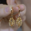 Women's earrings with stem leaf-shaped of golden Zircon elegant