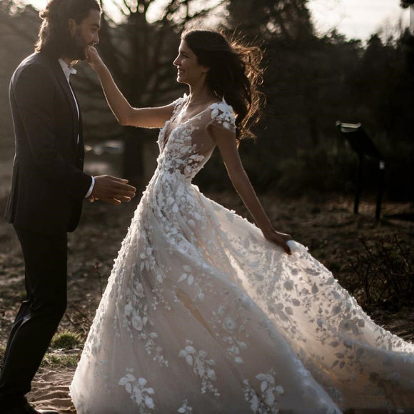 Elegant Bohemian Bridal Gown Featuring a Deep V-Neck, Short Sleeves, Exquisite 3D Floral Appliqués and a Sensual Open Back